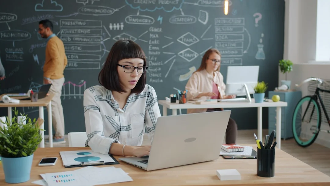 who-we-are A modern workspace featuring dual computer monitors displaying web design projects, emphasizing technology and productivity.